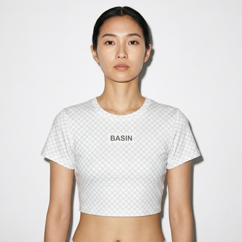 All-Over Print Crop Tee worn by a lean Japanese female fashion influencer, downtown streetwear styling, studio lookbook — custom all-over print crop tee