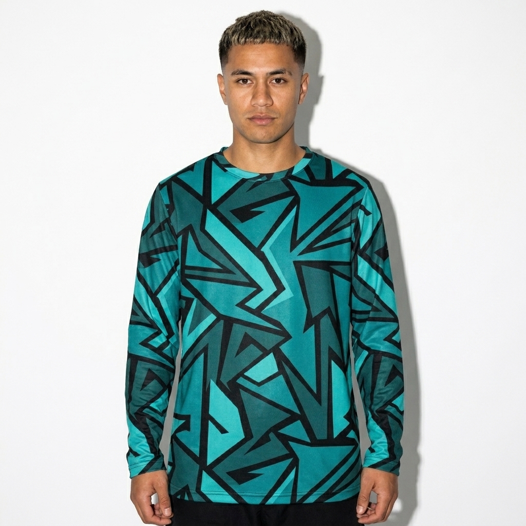 All-Over Print Long Sleeve Shirt worn by a petite Māori male fashion influencer, downtown streetwear styling, studio lookbook — custom all-over print long sleeve shirt