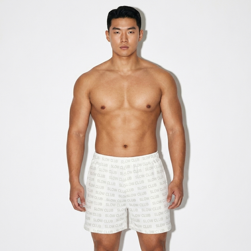 All-Over Print Unisex Cotton Shorts worn by a broad-shouldered East Asian male fashion influencer, downtown streetwear styling, studio lookbook — custom all-over print unisex cotton shorts