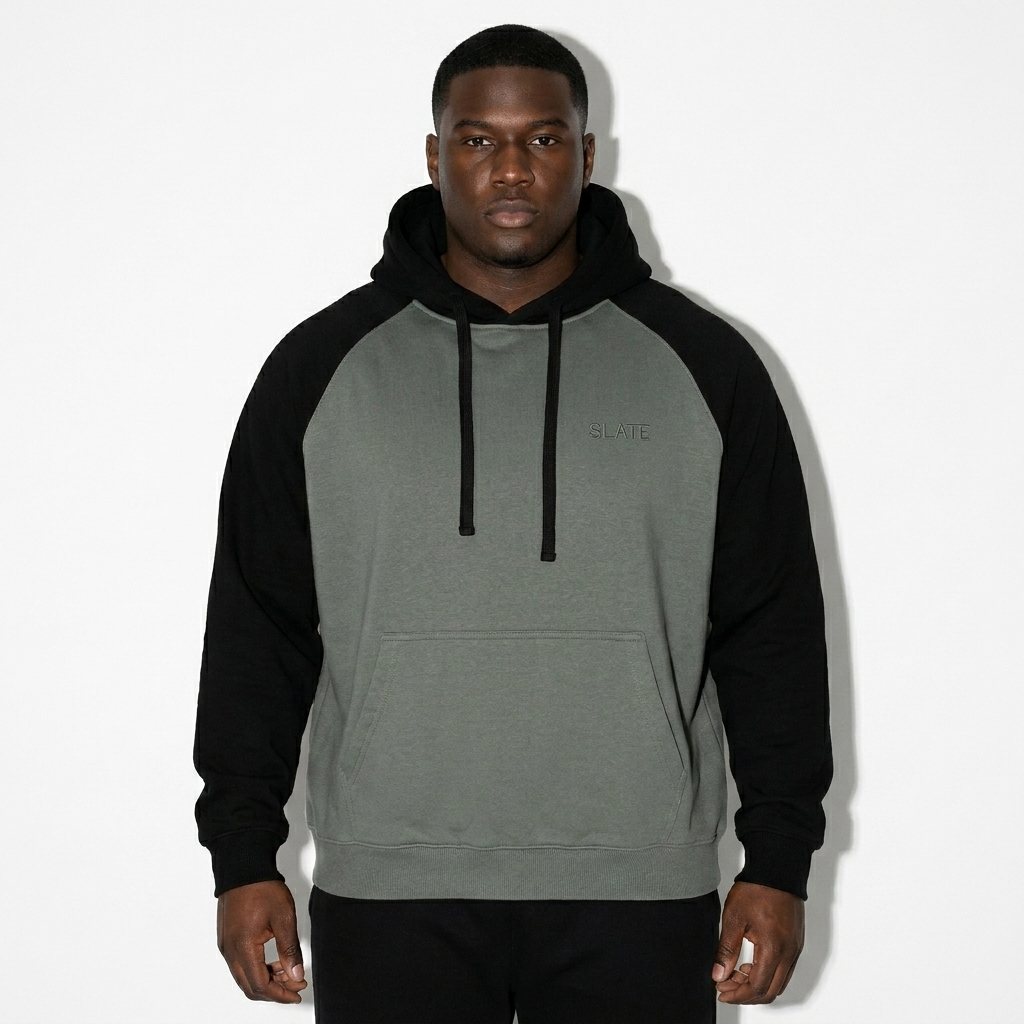 Color-Block Raglan Sleeve Hoodie worn by a broad-shouldered African American male fashion influencer, minimalist luxury styling, studio lookbook — custom color-block raglan sleeve hoodie