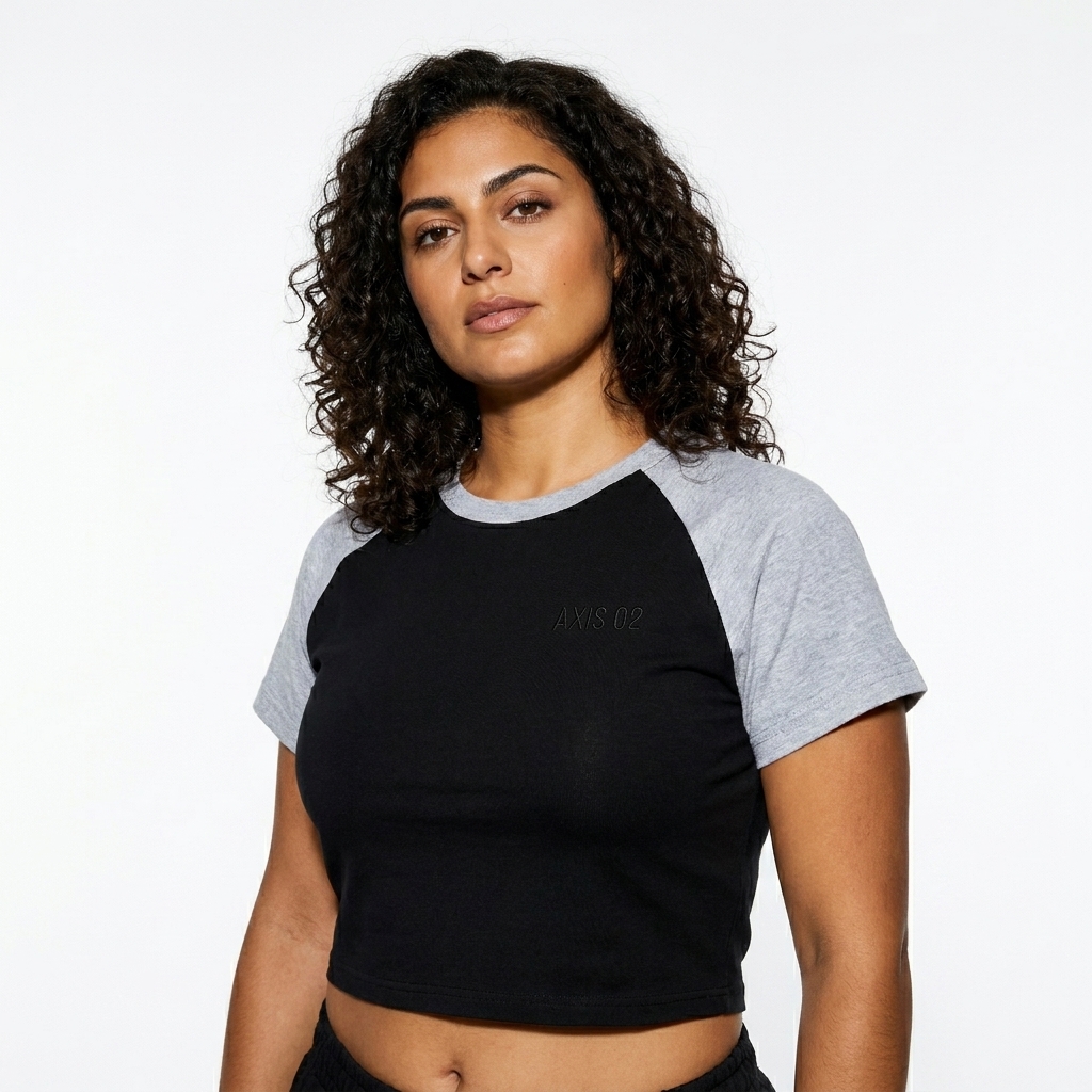 Color-Blocked Raglan Crop Top worn by a mid-size Mediterranean female fashion influencer, workwear utility styling, studio lookbook — custom color-blocked raglan crop top