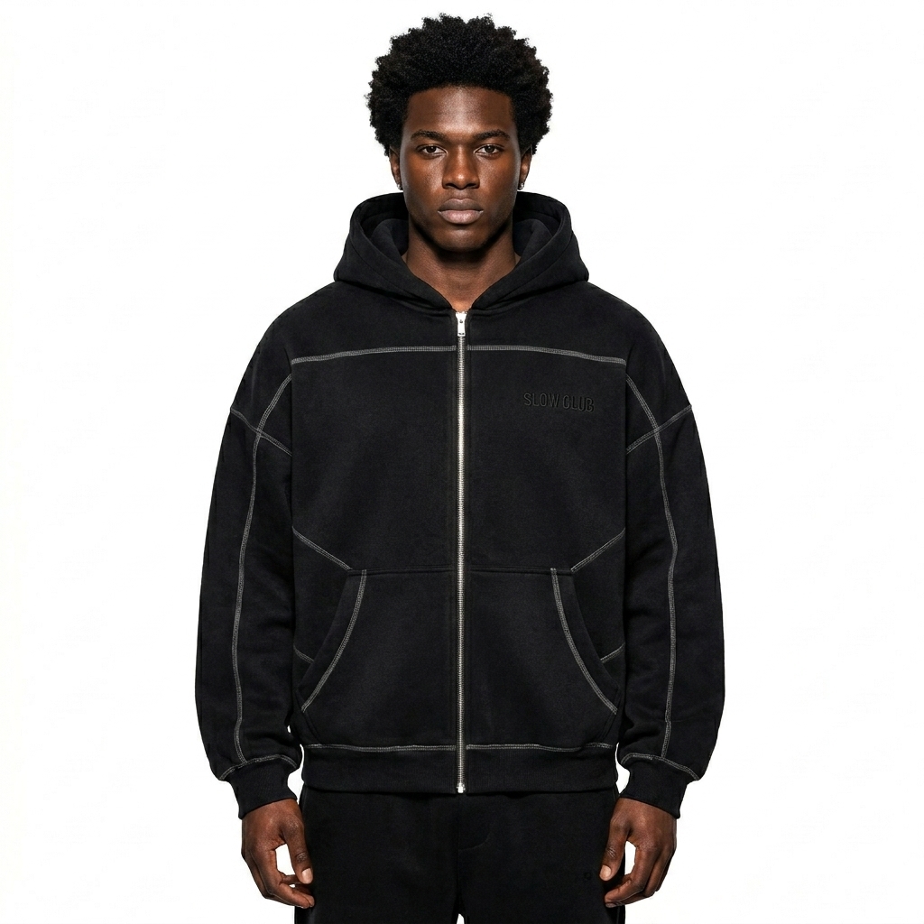 Contrast-Stitched Boxy Zip Hoodie worn by a broad-shouldered Afro-Caribbean male fashion influencer, gorpcore outdoor styling, studio lookbook — custom contrast-stitched boxy zip hoodie