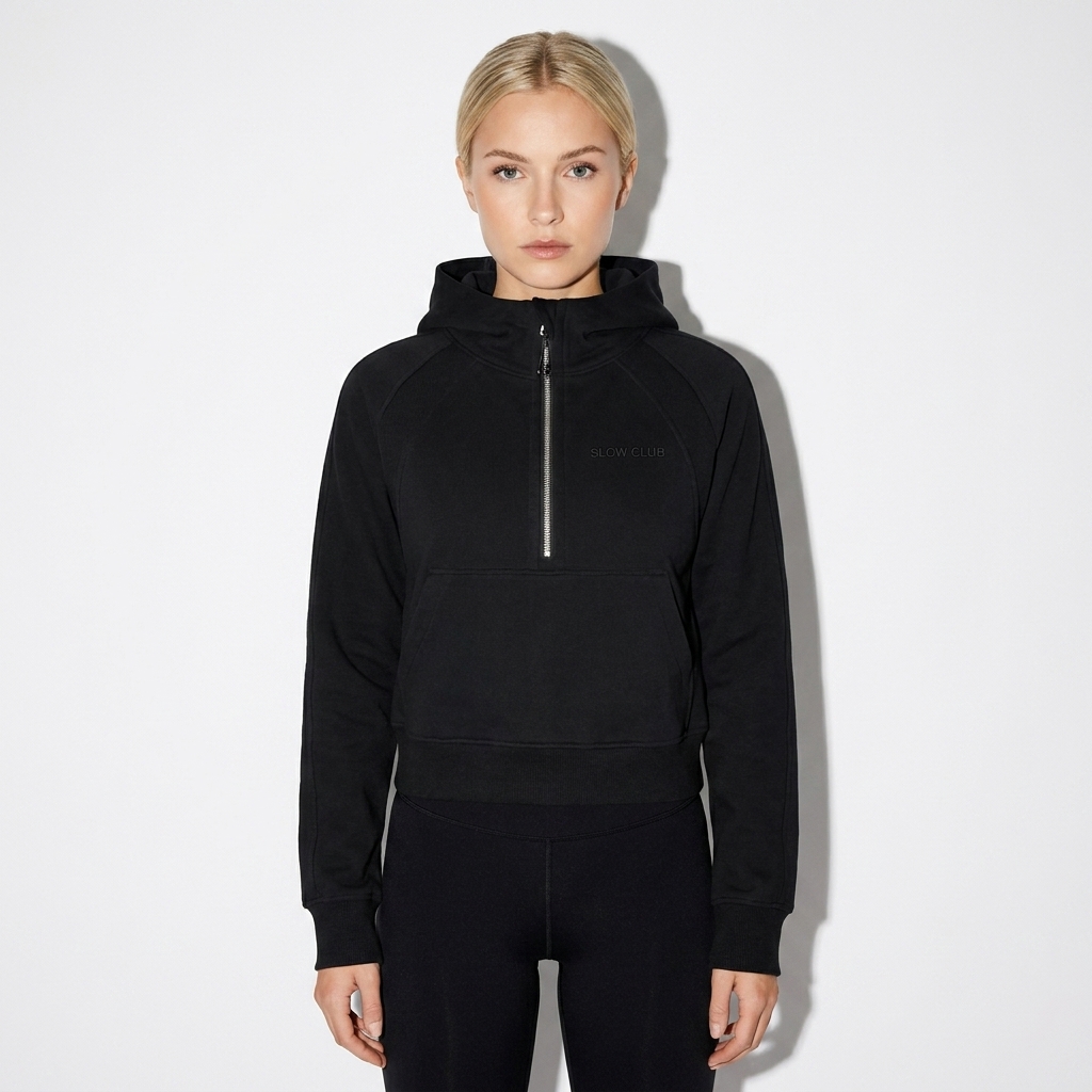 Cropped Half-Zip Hoodie worn by a petite German female fashion influencer, clean-girl minimal styling, studio lookbook — custom cropped half-zip hoodie