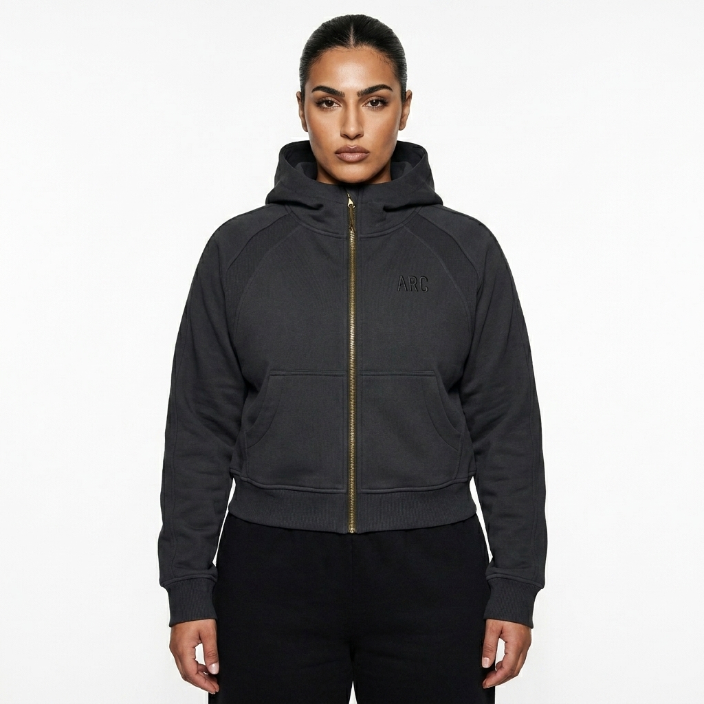 Cropped Zip-Up Hoodie worn by a broad-shouldered Middle Eastern female fashion influencer, editorial avant-garde styling, studio lookbook — custom cropped zip-up hoodie