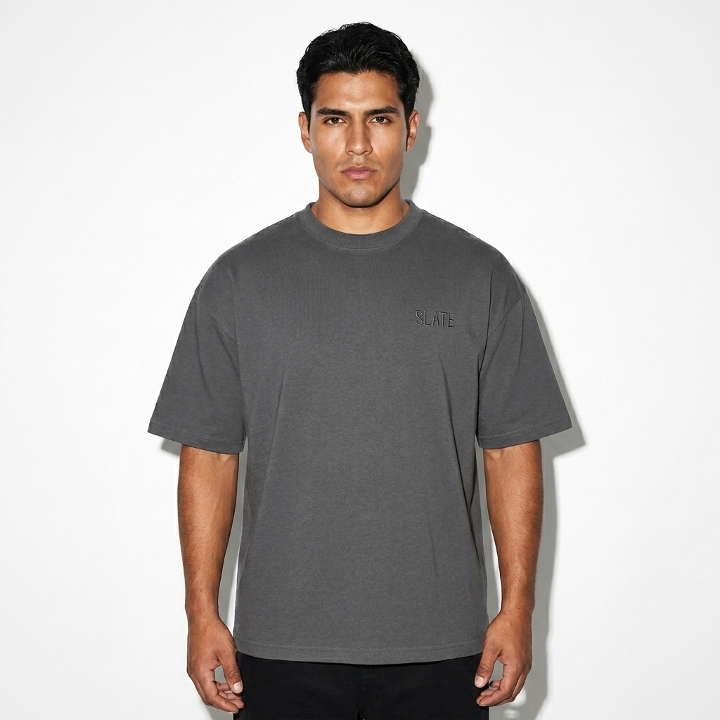 Boxy Oversized T-Shirt worn by a broad-shouldered Mexican male fashion influencer, techwear modern styling, studio lookbook — custom boxy oversized t-shirt