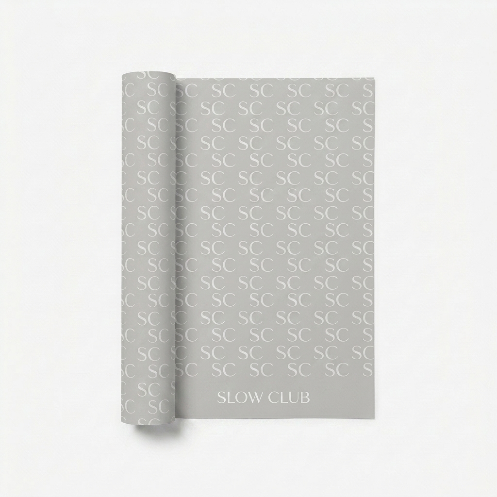 Custom Custom Wrapping Paper design direction 1: Subtle Monogram Repeat featuring the SLOW CLUB wordmark
