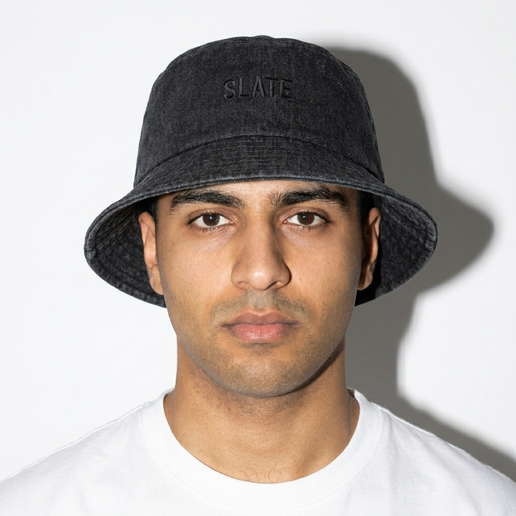 Denim Bucket Hat worn by a mid-size Arab male fashion influencer, editorial avant-garde styling, studio lookbook — custom denim bucket hat