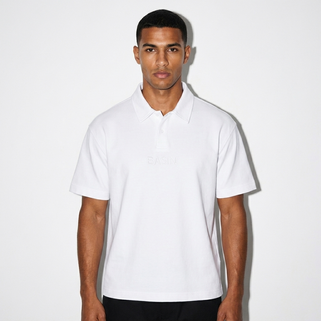 Drop Shoulder Short-Sleeve Polo worn by a toned North African male fashion influencer, preppy ivy styling, studio lookbook — custom drop shoulder short-sleeve polo