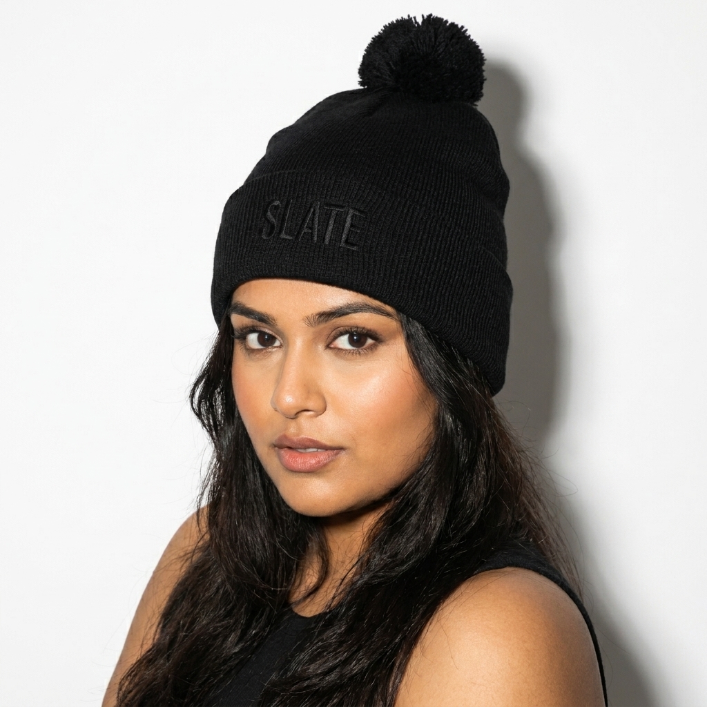 Pom-Pom Knit Cap worn by a curvy Indian female fashion influencer, gorpcore outdoor styling, studio lookbook — custom pom-pom knit cap