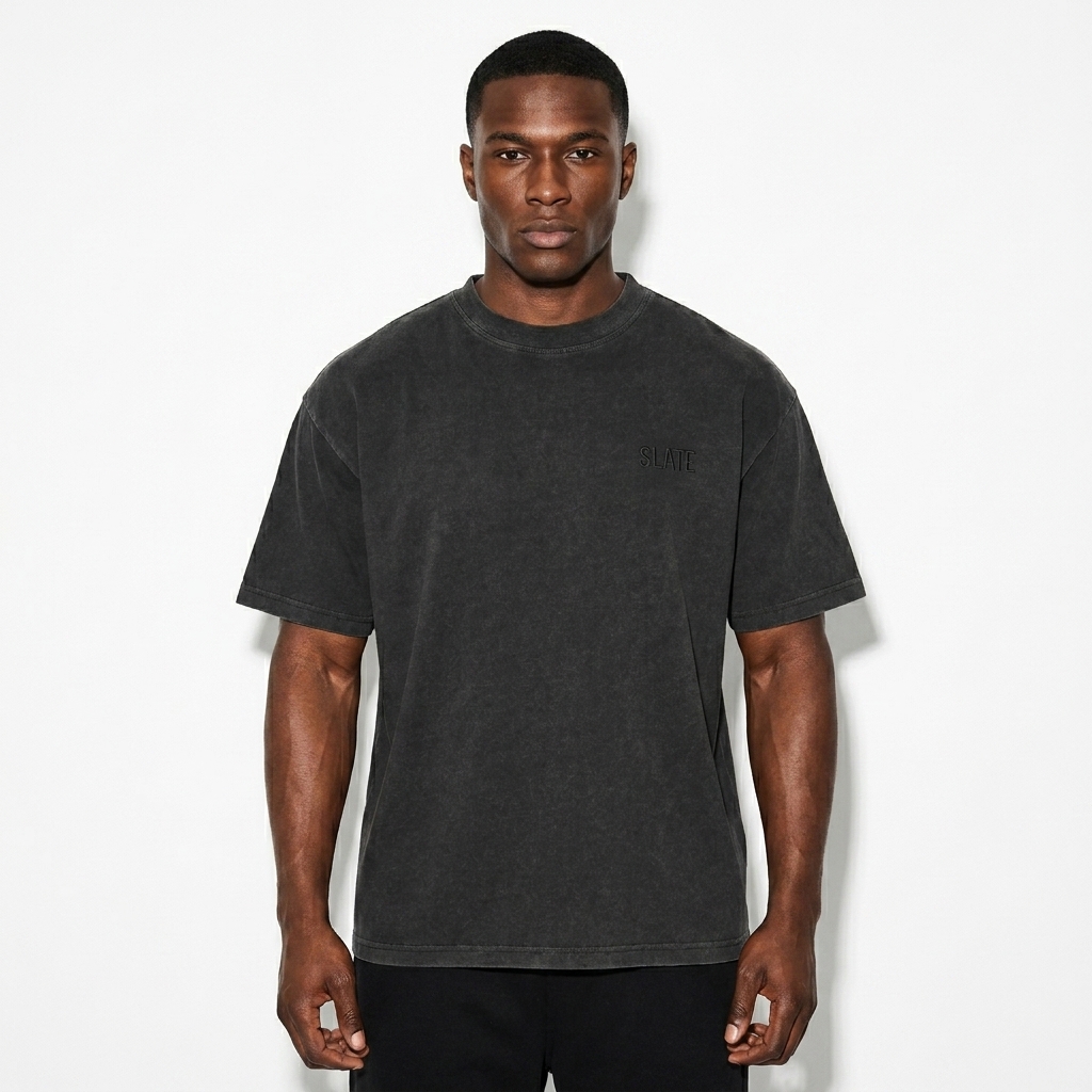 Enzyme Washed T-Shirt worn by a athletic muscular Afro-Caribbean male fashion influencer, workwear utility styling, studio lookbook — custom enzyme washed t-shirt