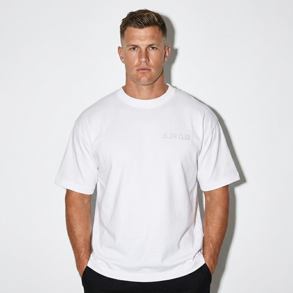Essential Cotton Boxy T-Shirt worn by a broad-shouldered Australian male fashion influencer, clean-girl minimal styling, studio lookbook — custom essential cotton boxy t-shirt
