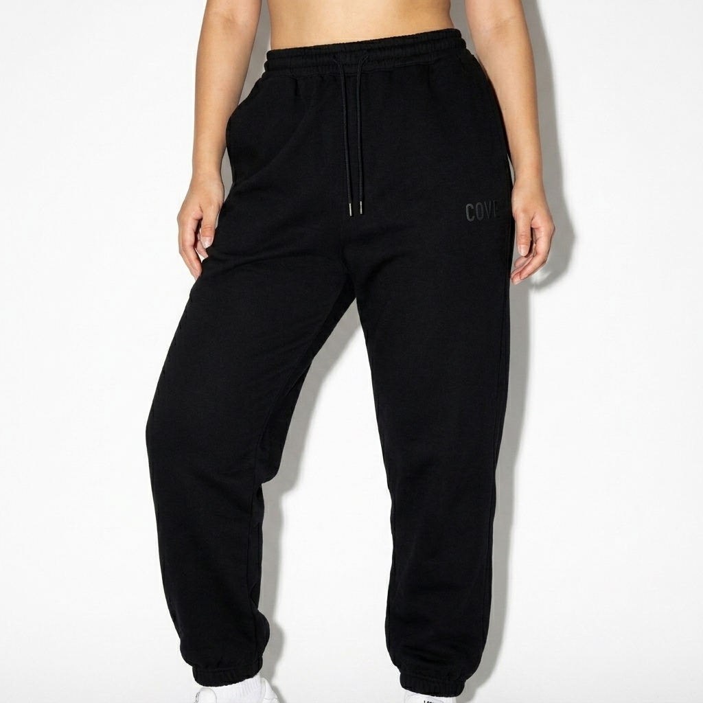 Essential Jogger Sweatpants worn by a mid-size East Asian female fashion influencer, sporty athleisure styling, studio lookbook — custom essential jogger sweatpants