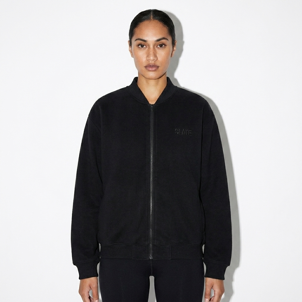Essential Zip-Up Varsity Jacket worn by a slim tall Māori female fashion influencer, techwear modern styling, studio lookbook — custom essential zip-up varsity jacket