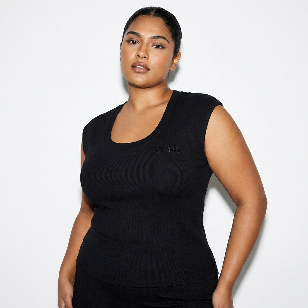 Fitted Sleeveless T-Shirt worn by a curvy Indian female fashion influencer, sporty athleisure styling, studio lookbook — custom fitted sleeveless t-shirt