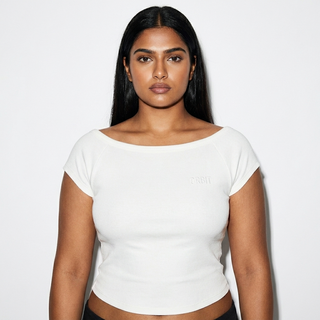 Fitted Wide Neck T-Shirt worn by a broad-shouldered South Asian female fashion influencer, editorial avant-garde styling, studio lookbook — custom fitted wide neck t-shirt