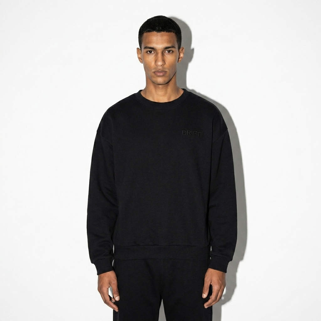 Heavyweight Drop-Shoulder Sweatshirt worn by a slim tall North African male fashion influencer, editorial avant-garde styling, studio lookbook — custom heavyweight drop-shoulder sweatshirt