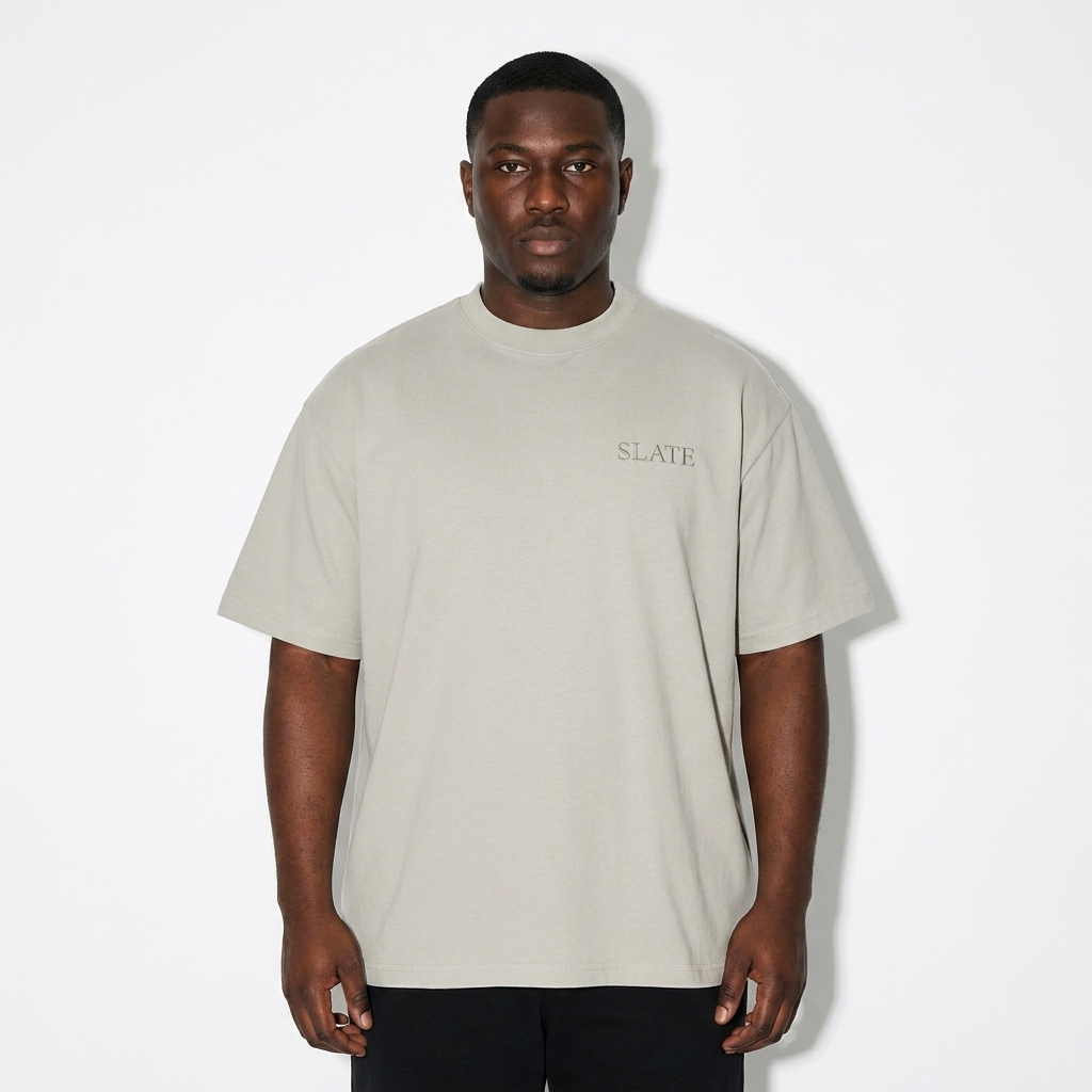 Heavyweight Loose Fit T-Shirt worn by a curvy West African male fashion influencer, minimalist luxury styling, studio lookbook — custom heavyweight loose fit t-shirt