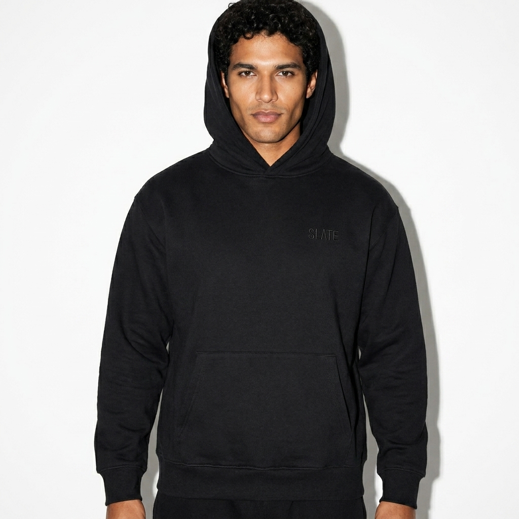 Oversized Heavyweight Pullover Hoodie worn by a mid-size Brazilian male fashion influencer, minimalist luxury styling, studio lookbook — custom oversized heavyweight pullover hoodie