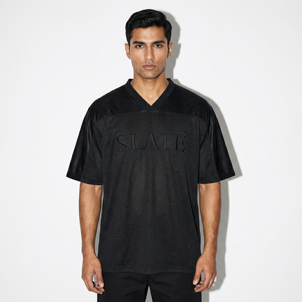 Oversized Mesh V-Neck Soccer Jersey worn by a toned Pakistani male fashion influencer, downtown streetwear styling, studio lookbook — custom oversized mesh v-neck soccer jersey