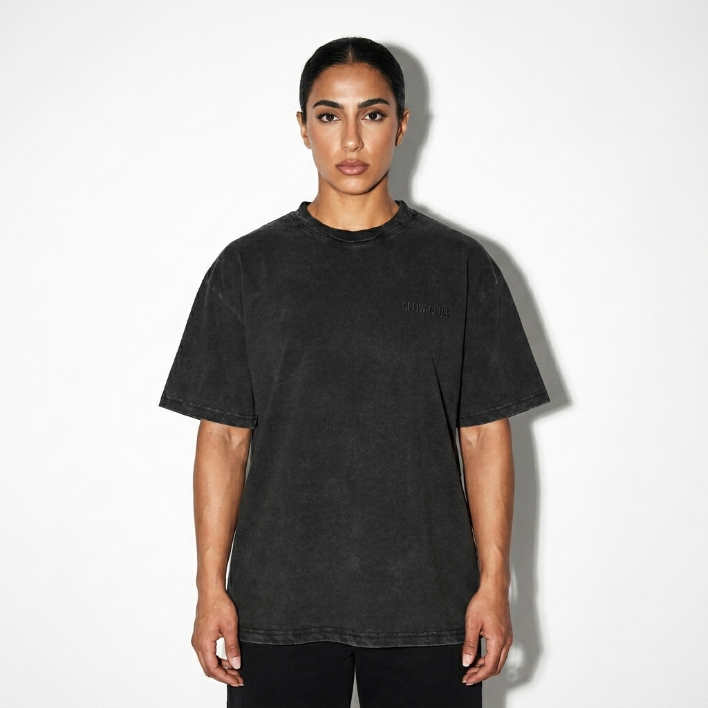 Snow Washed Raw-Edge T-Shirt worn by a athletic muscular Arab female fashion influencer, minimalist luxury styling, studio lookbook — custom snow washed raw-edge t-shirt