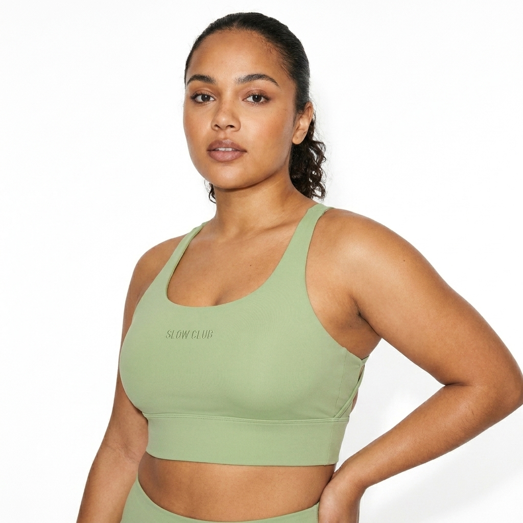 Strappy Criss-Cross Sports Bra worn by a curvy Mixed-race female fashion influencer, downtown streetwear styling, studio lookbook — custom strappy criss-cross sports bra