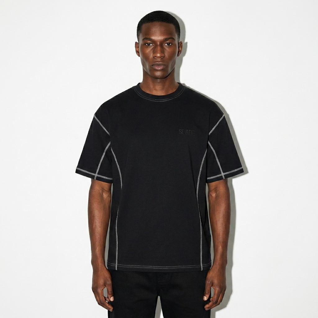 Streetwear Contrast-Stitched T-Shirt worn by a slim tall Afro-Caribbean male fashion influencer, sporty athleisure styling, studio lookbook — custom streetwear contrast-stitched t-shirt