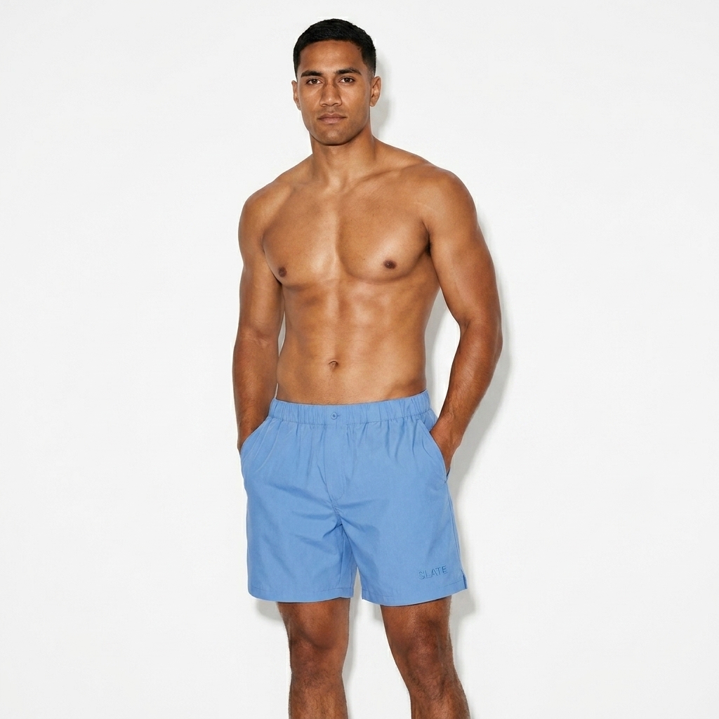Striped Elastic Waist Shorts worn by a toned Māori male fashion influencer, clean-girl minimal styling, studio lookbook — custom striped elastic waist shorts