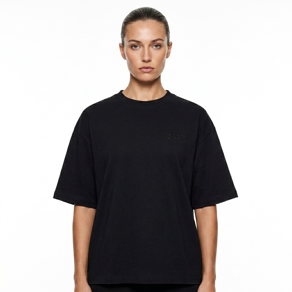 Unisex Boxy Oversized T-Shirt worn by a toned British female fashion influencer, minimalist luxury styling, studio lookbook — custom unisex boxy oversized t-shirt