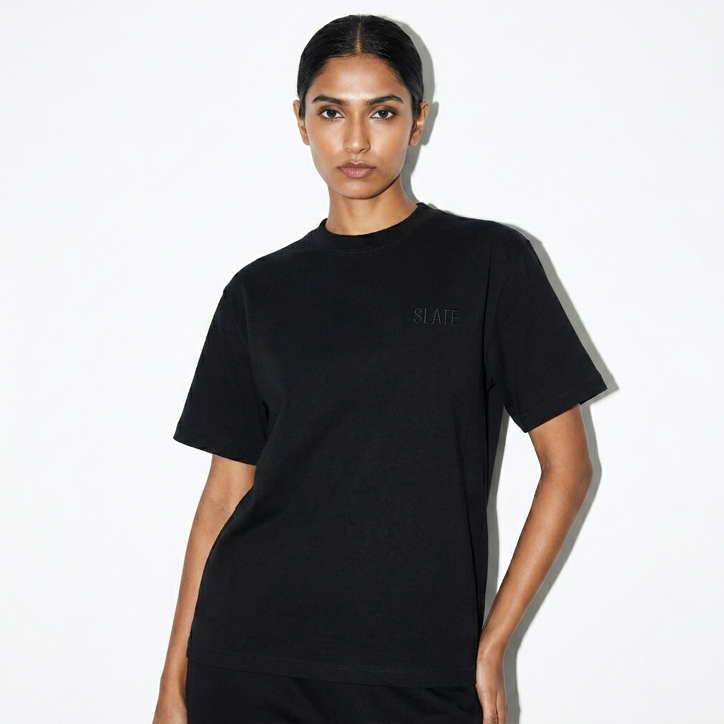 Unisex Boxy T-Shirt worn by a lean Indian female fashion influencer, clean-girl minimal styling, studio lookbook — custom unisex boxy t-shirt