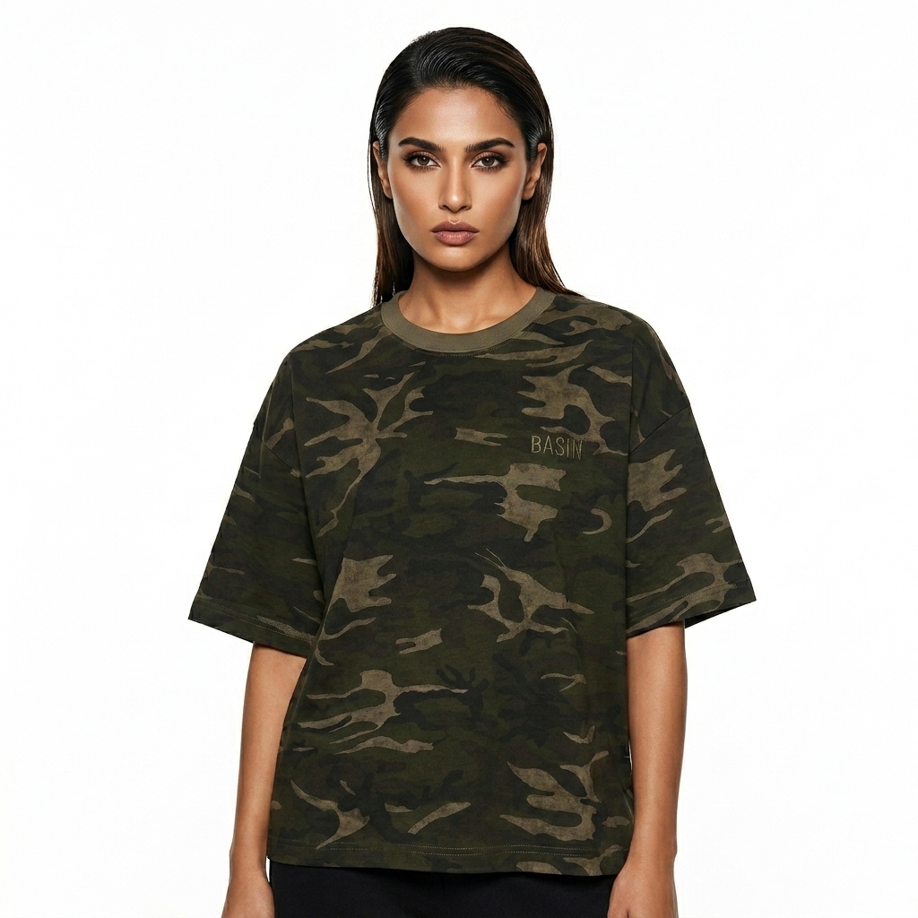 Unisex Camo Boxy T-Shirt worn by a toned Pakistani female fashion influencer, sporty athleisure styling, studio lookbook — custom unisex camo boxy t-shirt