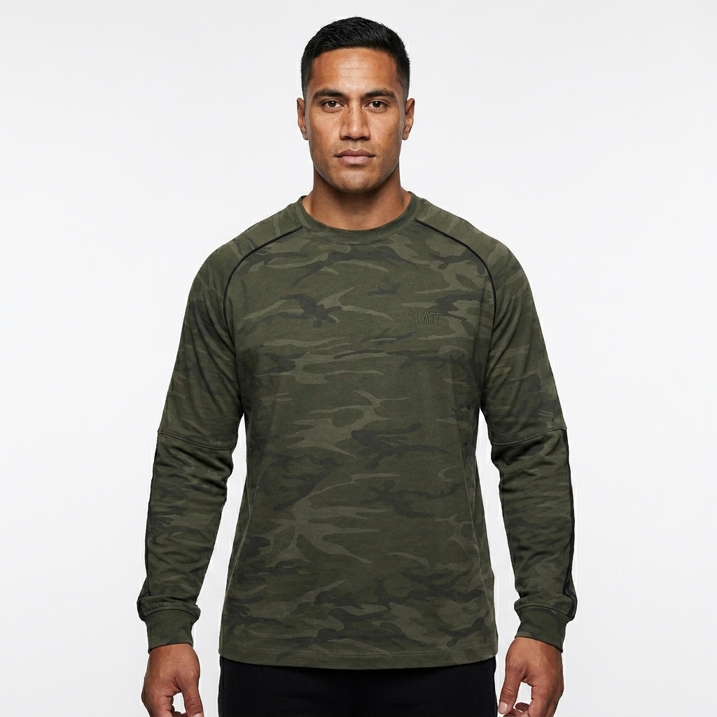 Unisex Camo Long Sleeve T-Shirt worn by a athletic muscular Māori male fashion influencer, y2k revival styling, studio lookbook — custom unisex camo long sleeve t-shirt