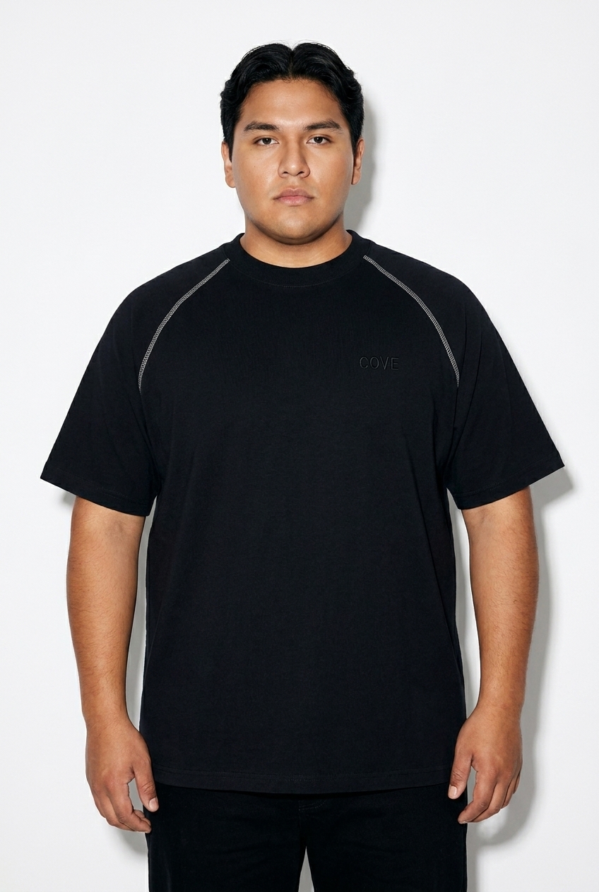 Unisex Contrast Stitch Raglan T-Shirt worn by a curvy Indigenous American male fashion influencer, minimalist luxury styling, studio lookbook — custom unisex contrast stitch raglan t-shirt