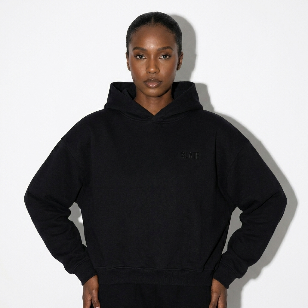 Unisex Cropped Hoodie worn by a broad-shouldered East African female fashion influencer, sporty athleisure styling, studio lookbook — custom unisex cropped hoodie