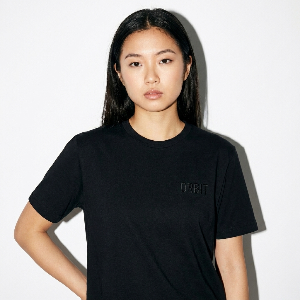 Unisex Fine Jersey Tee worn by a petite East Asian female fashion influencer, gorpcore outdoor styling, studio lookbook — custom unisex fine jersey tee