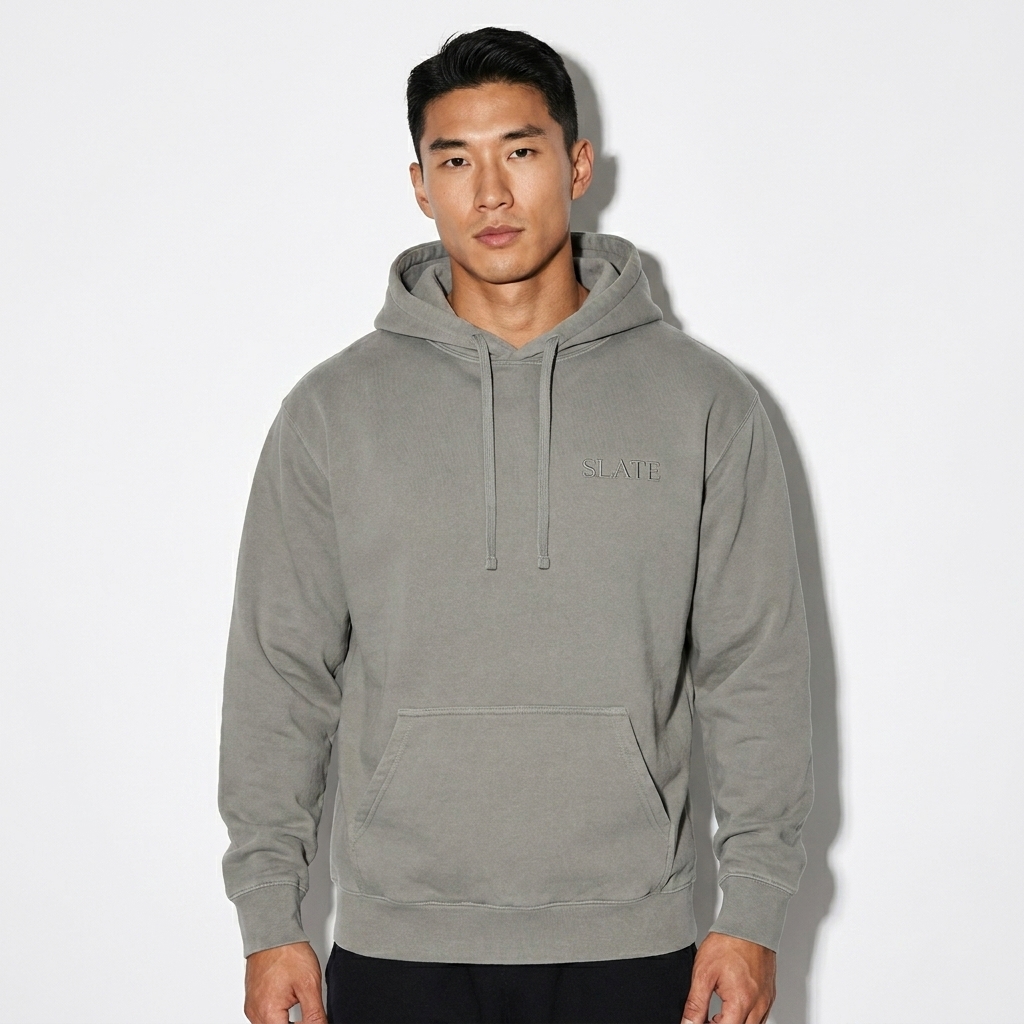 Unisex Garment-Dyed Hoodie worn by a athletic muscular East Asian male fashion influencer, preppy ivy styling, studio lookbook — custom unisex garment-dyed hoodie