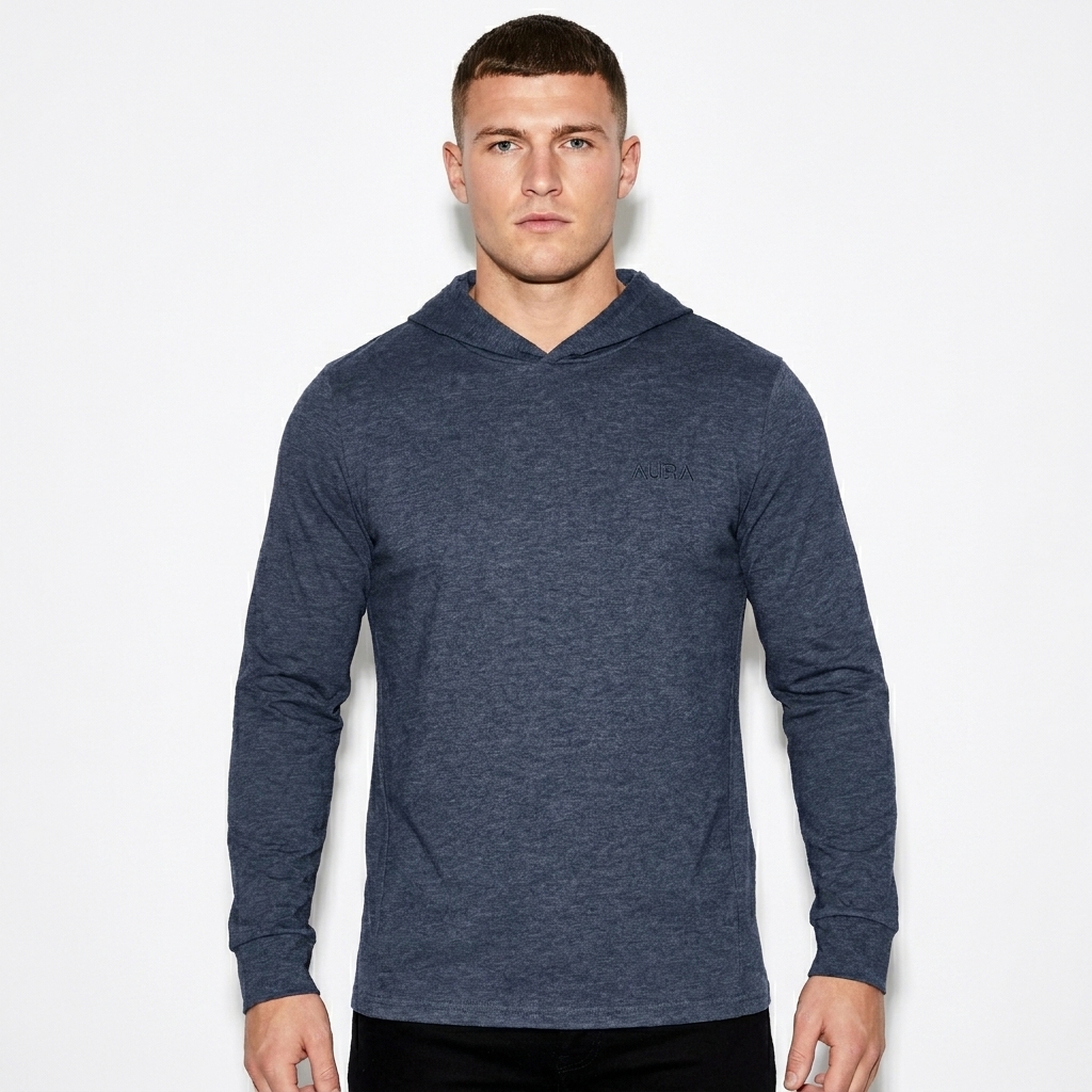 Unisex Hooded Long Sleeve Tee worn by a broad-shouldered British male fashion influencer, minimalist luxury styling, studio lookbook — custom unisex hooded long sleeve tee