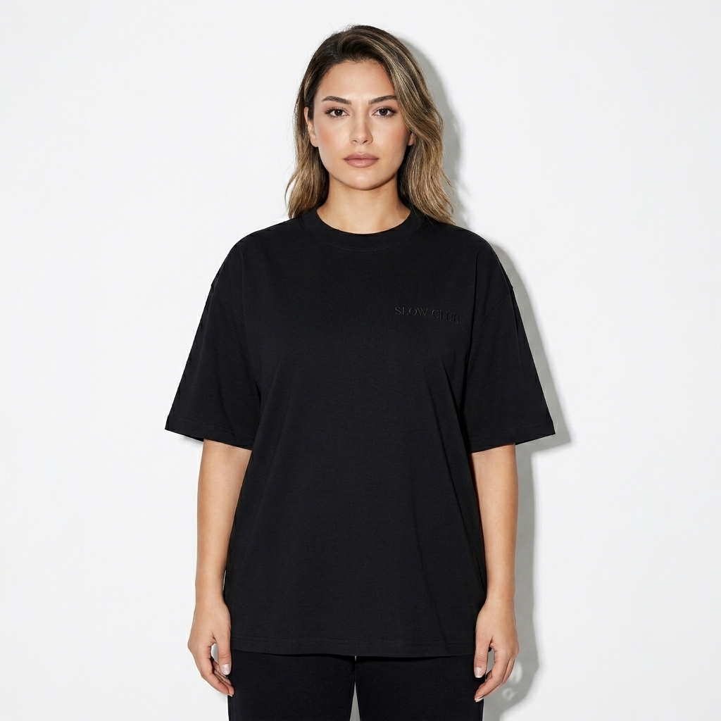 Unisex Loose Drop Shoulder T-Shirt worn by a mid-size Turkish female fashion influencer, workwear utility styling, studio lookbook — custom unisex loose drop shoulder t-shirt
