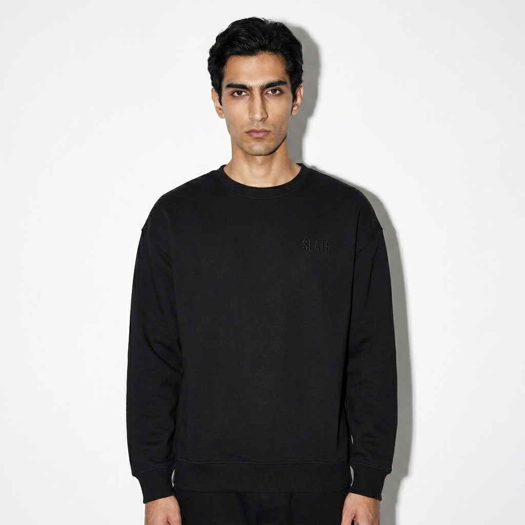 Unisex Organic Crewneck Sweatshirt worn by a slim tall Persian male fashion influencer, techwear modern styling, studio lookbook — custom unisex organic crewneck sweatshirt