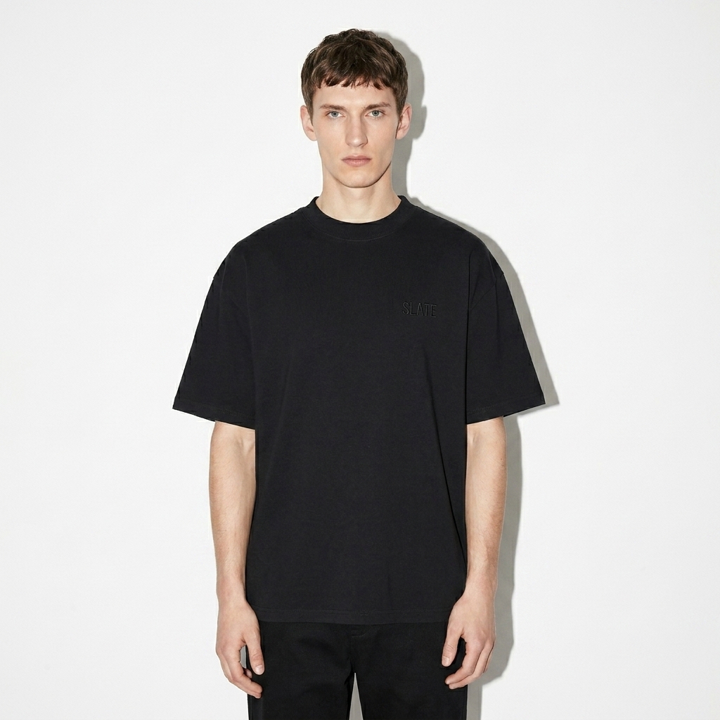 Unisex Organic Oversized High-Neck T-Shirt worn by a slim tall British male fashion influencer, workwear utility styling, studio lookbook — custom unisex organic oversized high-neck t-shirt