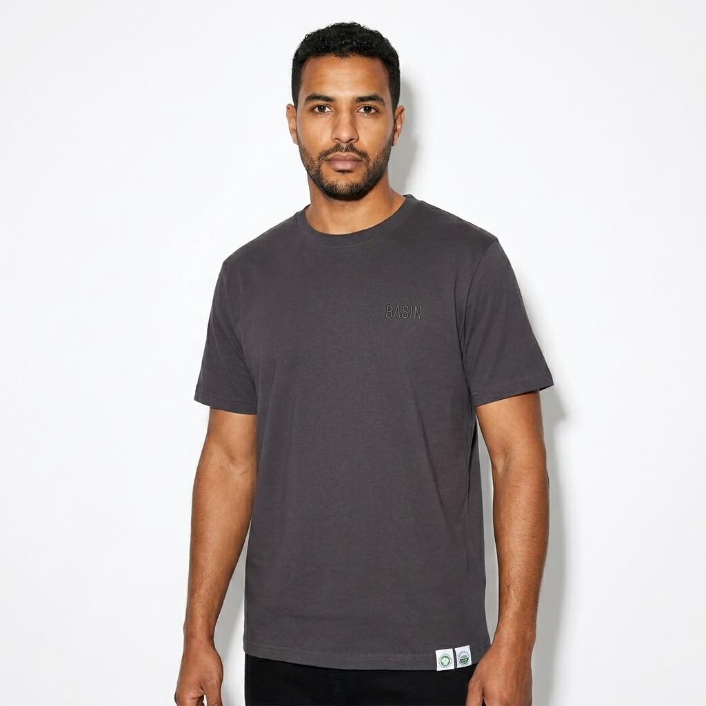 Unisex Organic Ribbed Neck T-Shirt worn by a mid-size North African male fashion influencer, downtown streetwear styling, studio lookbook — custom unisex organic ribbed neck t-shirt