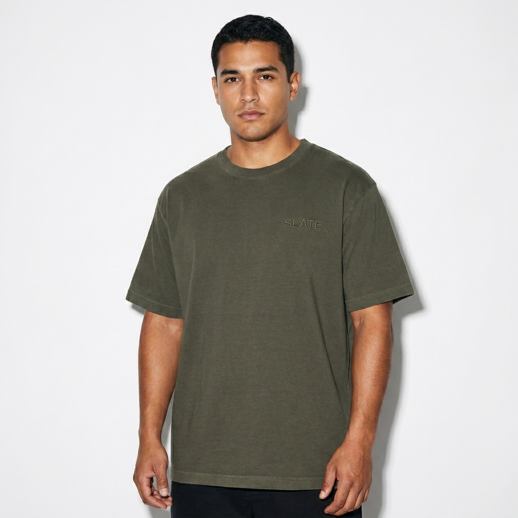 Unisex Oversized Garment-Dyed T-Shirt worn by a mid-size Hispanic male fashion influencer, editorial avant-garde styling, studio lookbook — custom unisex oversized garment-dyed t-shirt