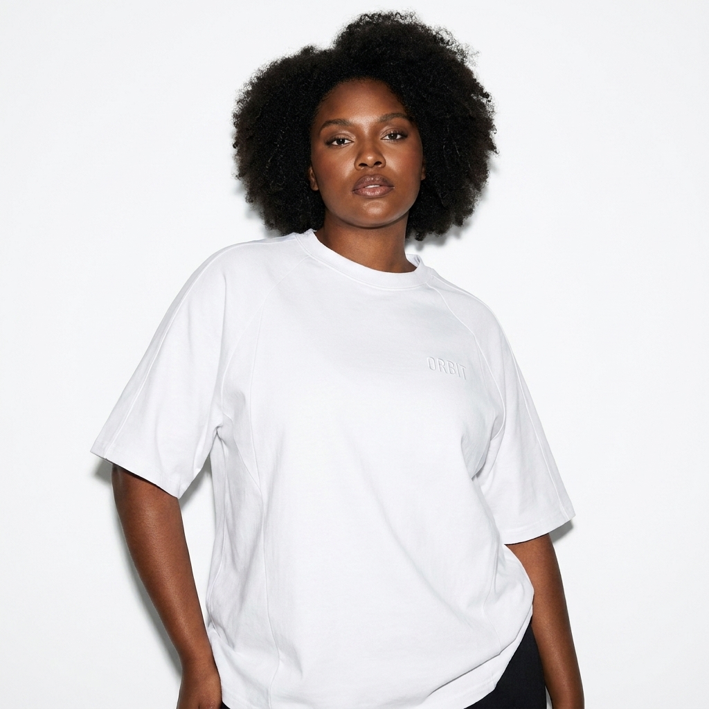 Unisex Oversized Paneled Raglan T-Shirt worn by a curvy African American female fashion influencer, techwear modern styling, studio lookbook — custom unisex oversized paneled raglan t-shirt