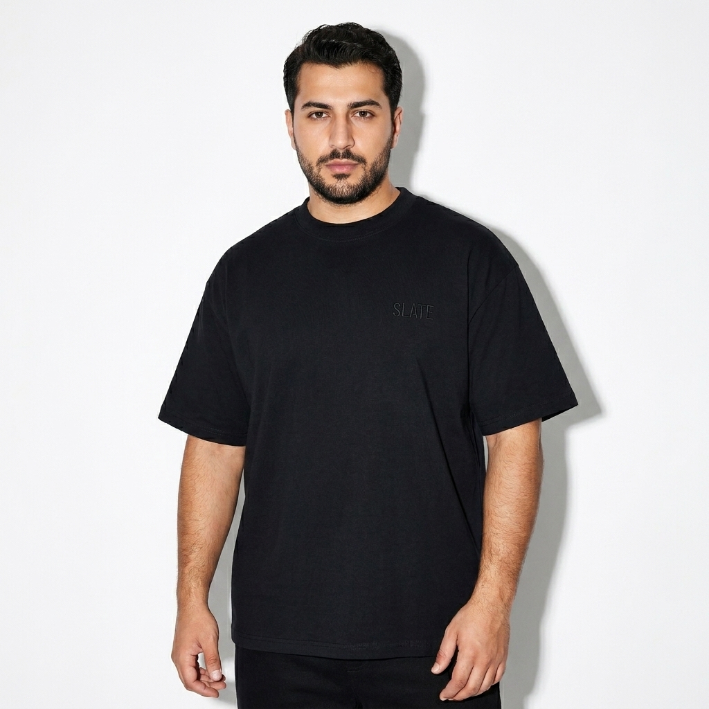 Unisex Oversized T-Shirt worn by a curvy Turkish male fashion influencer, workwear utility styling, studio lookbook — custom unisex oversized t-shirt