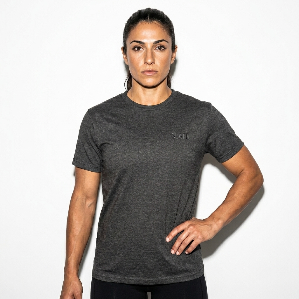 Unisex Performance T-Shirt worn by a athletic muscular Mediterranean female fashion influencer, minimalist luxury styling, studio lookbook — custom unisex performance t-shirt