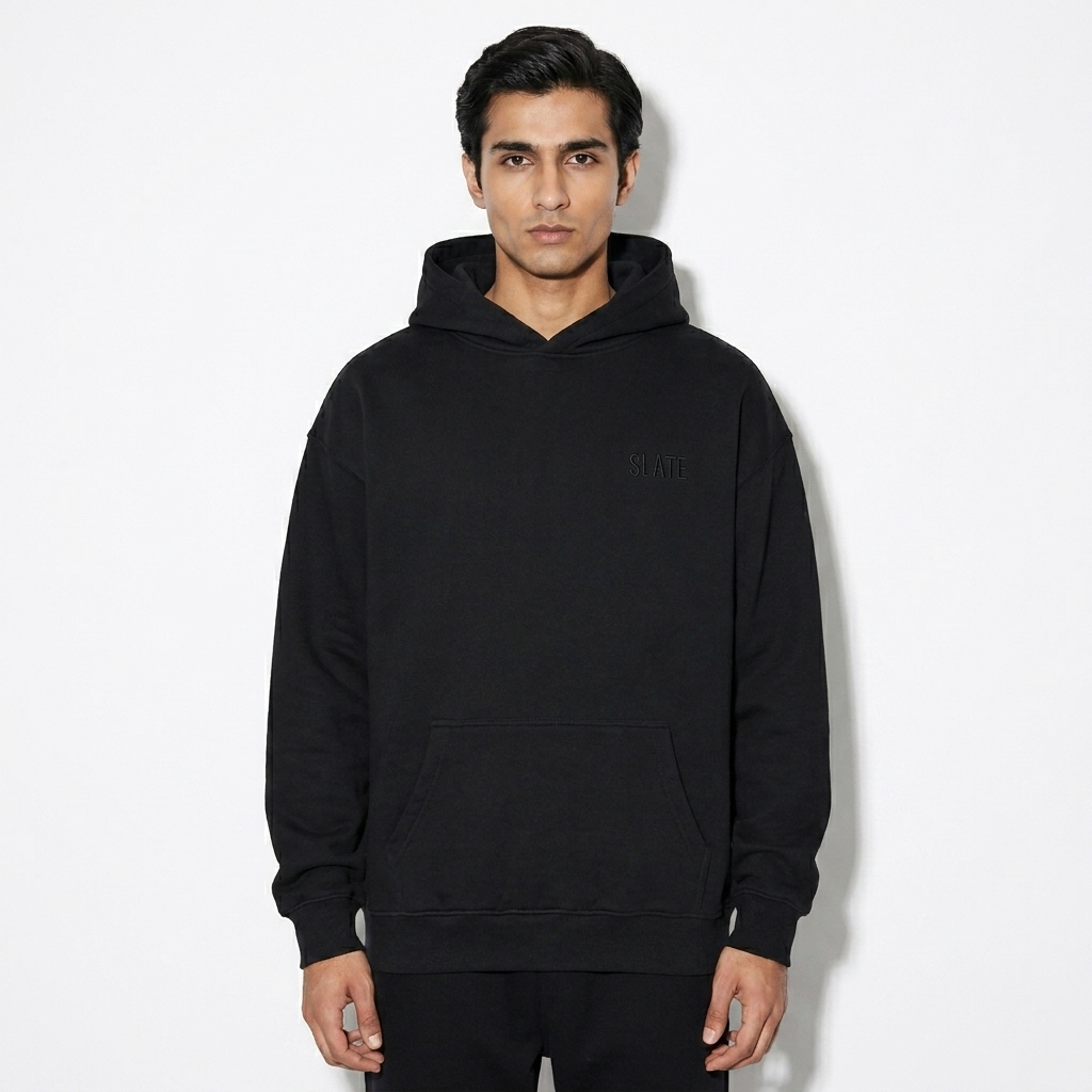 Unisex Relaxed Fleece Hoodie worn by a lean Pakistani male fashion influencer, gorpcore outdoor styling, studio lookbook — custom unisex relaxed fleece hoodie