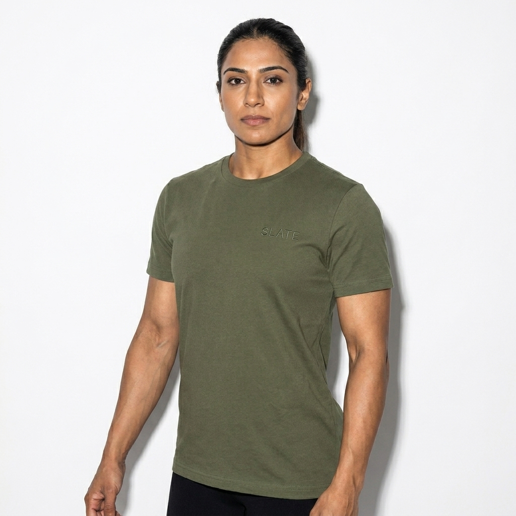 Unisex Staple T-Shirt worn by a athletic muscular Pakistani female fashion influencer, y2k revival styling, studio lookbook — custom unisex staple t-shirt