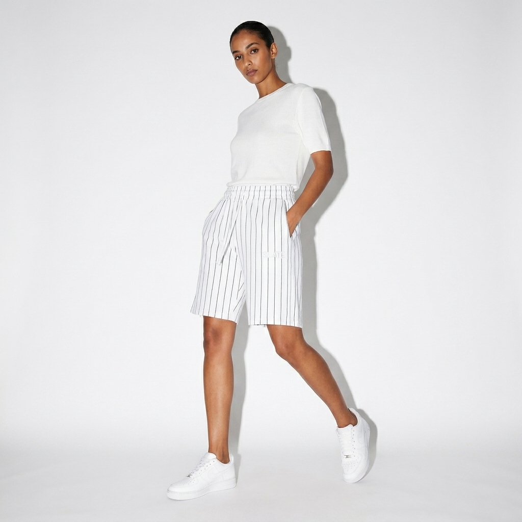 Unisex Striped Loose Fit Shorts worn by a lean North African female fashion influencer, minimalist luxury styling, studio lookbook — custom unisex striped loose fit shorts