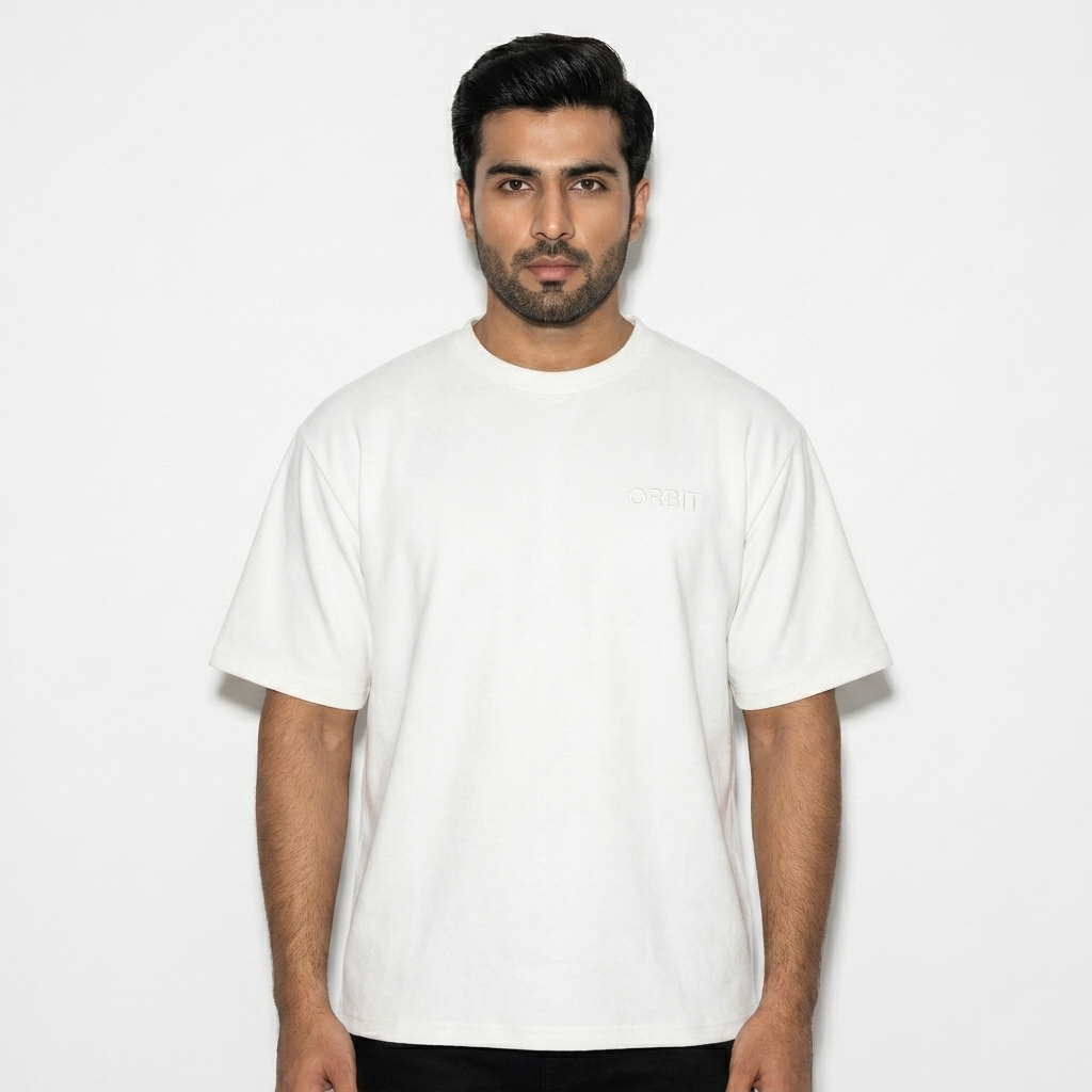 Unisex Sueded Cotton T-Shirt worn by a broad-shouldered Pakistani male fashion influencer, techwear modern styling, studio lookbook — custom unisex sueded cotton t-shirt