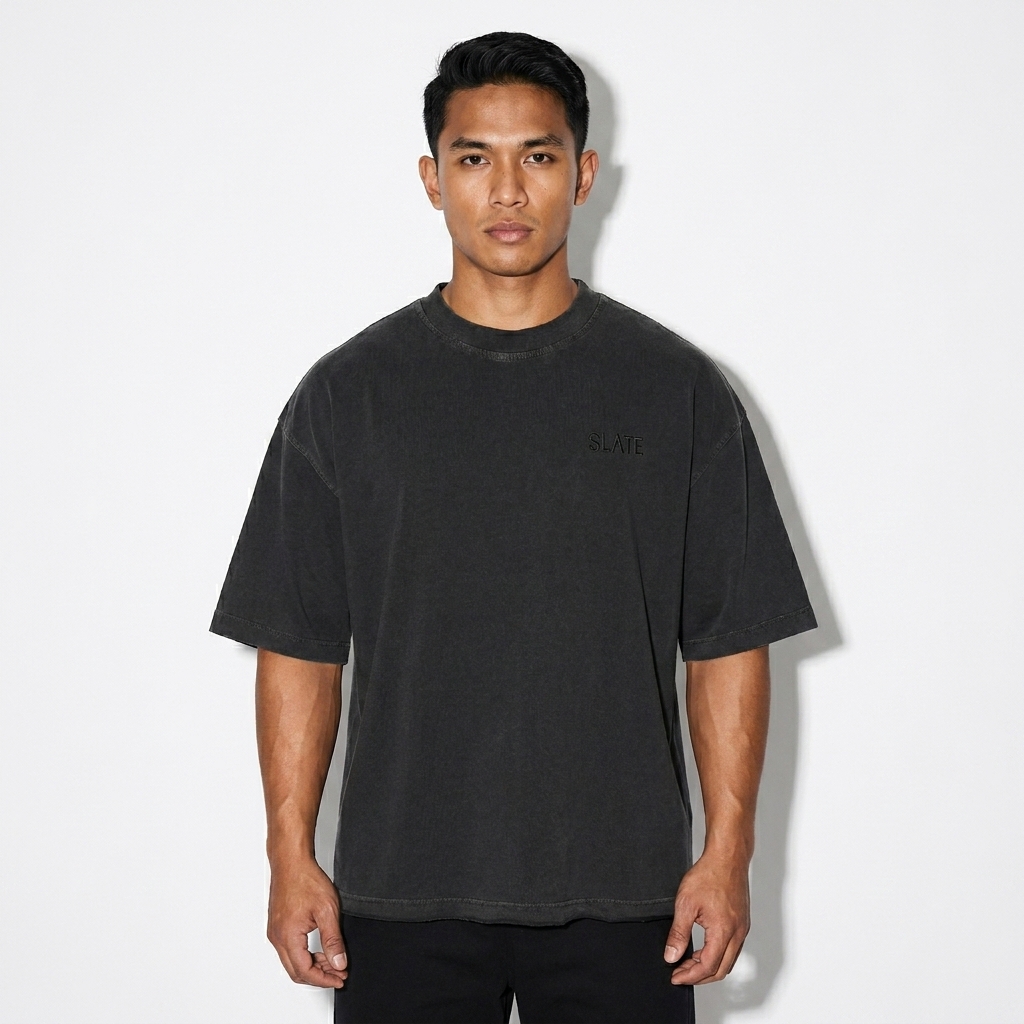 Unisex Vintage Wash Boxy T-Shirt worn by a athletic muscular Filipino male fashion influencer, techwear modern styling, studio lookbook — custom unisex vintage wash boxy t-shirt