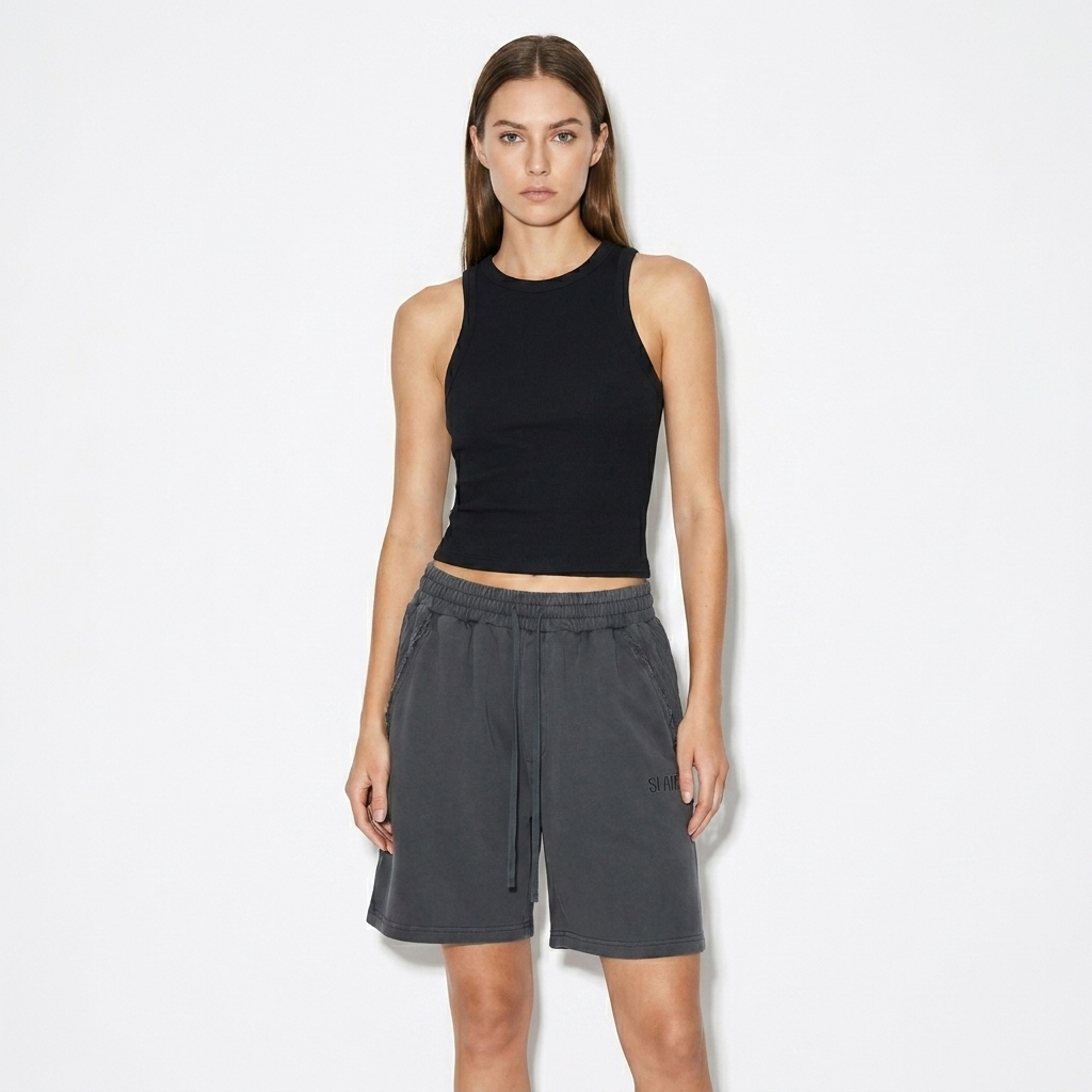 Unisex Vintage Wash Raw Edge Shorts worn by a lean White American female fashion influencer, sporty athleisure styling, studio lookbook — custom unisex vintage wash raw edge shorts